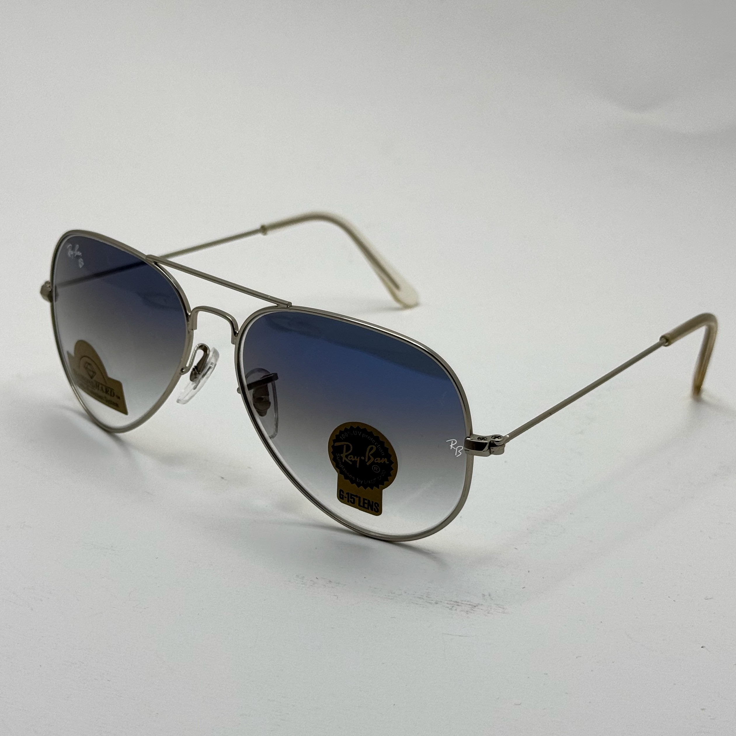 عینک ریبن خلبانی شیشه سنگ آبی هایلایت فریم نقره ای به همراه پک کامل ریبن کد Rayban RB 3025