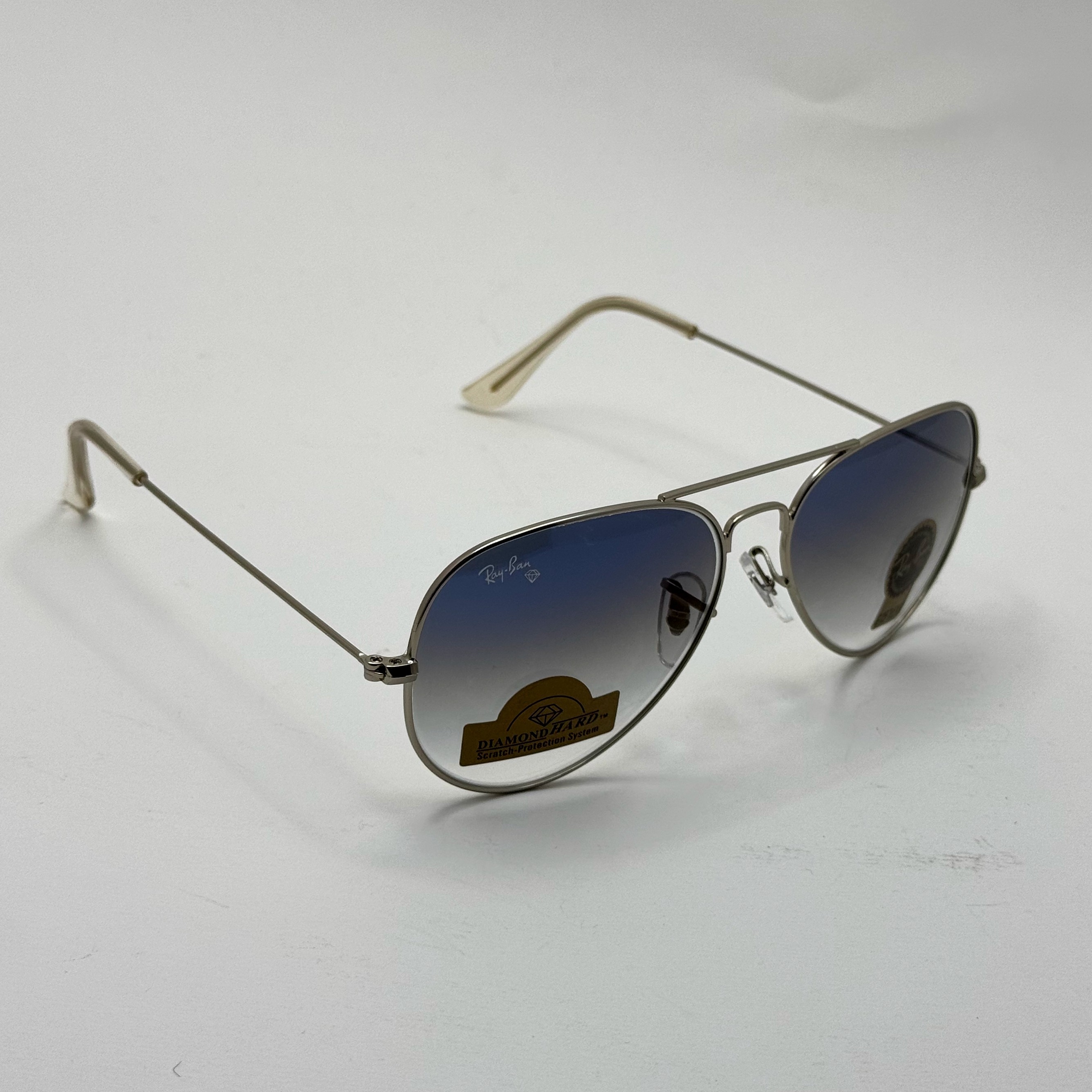 عینک ریبن خلبانی شیشه سنگ آبی هایلایت فریم نقره ای به همراه پک کامل ریبن کد Rayban RB 3025