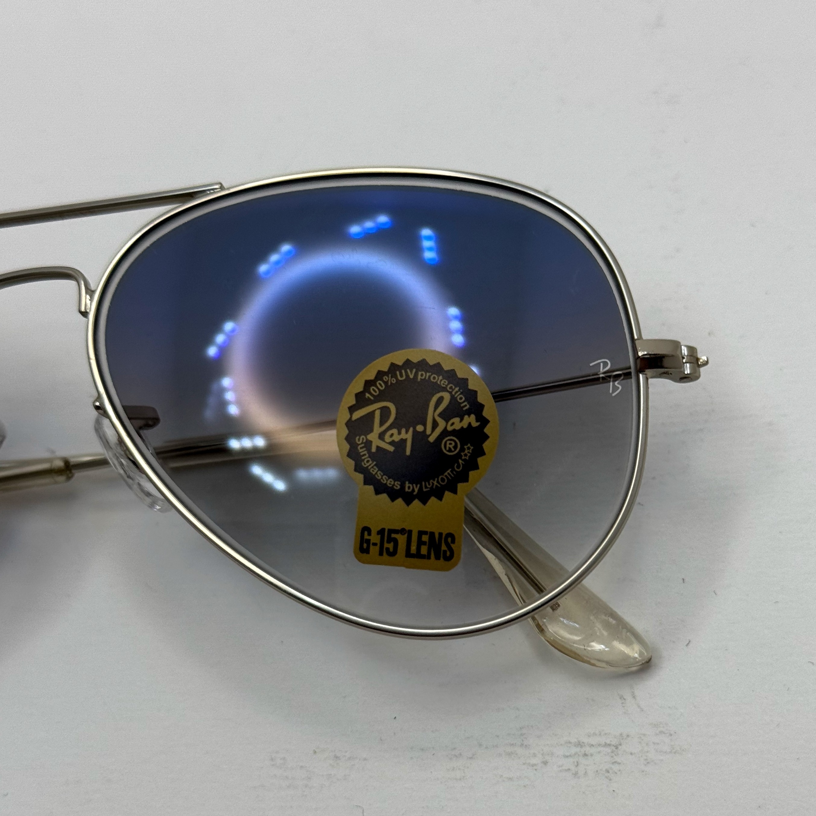 عینک ریبن خلبانی شیشه سنگ آبی هایلایت فریم نقره ای به همراه پک کامل ریبن Rayban RB 3025 (ارسال رایگان)